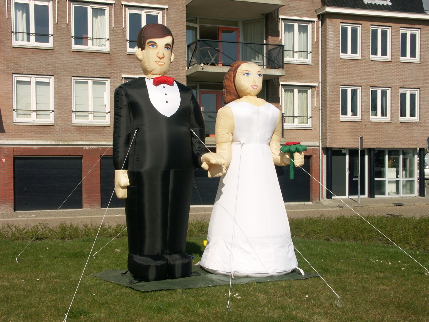 Bruidspaar, 2 poppen in trouwkleding die hand in hand staan. kan worden geleverd met een groot spandoek: Keuze uit: 12 1/2, 25, 40, 50 of 60 jaar getrouwd.