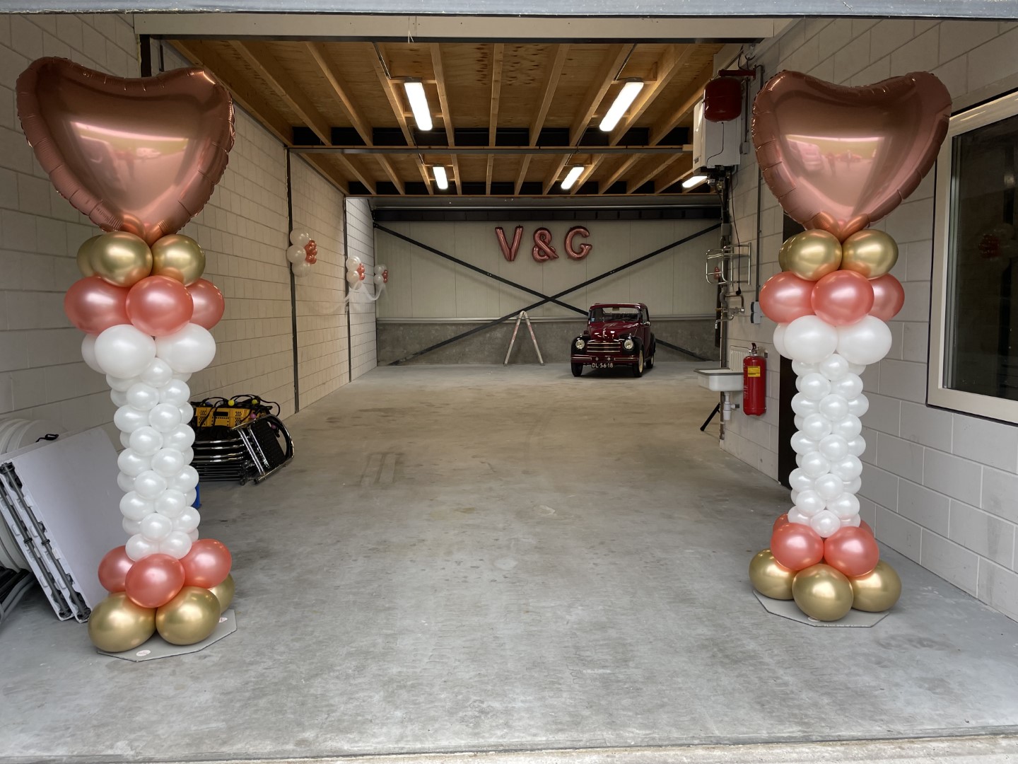 Ballonnenpilaren met een smaller geblazen midden en breed onder en bovengedeelte met een foliehart topballon.