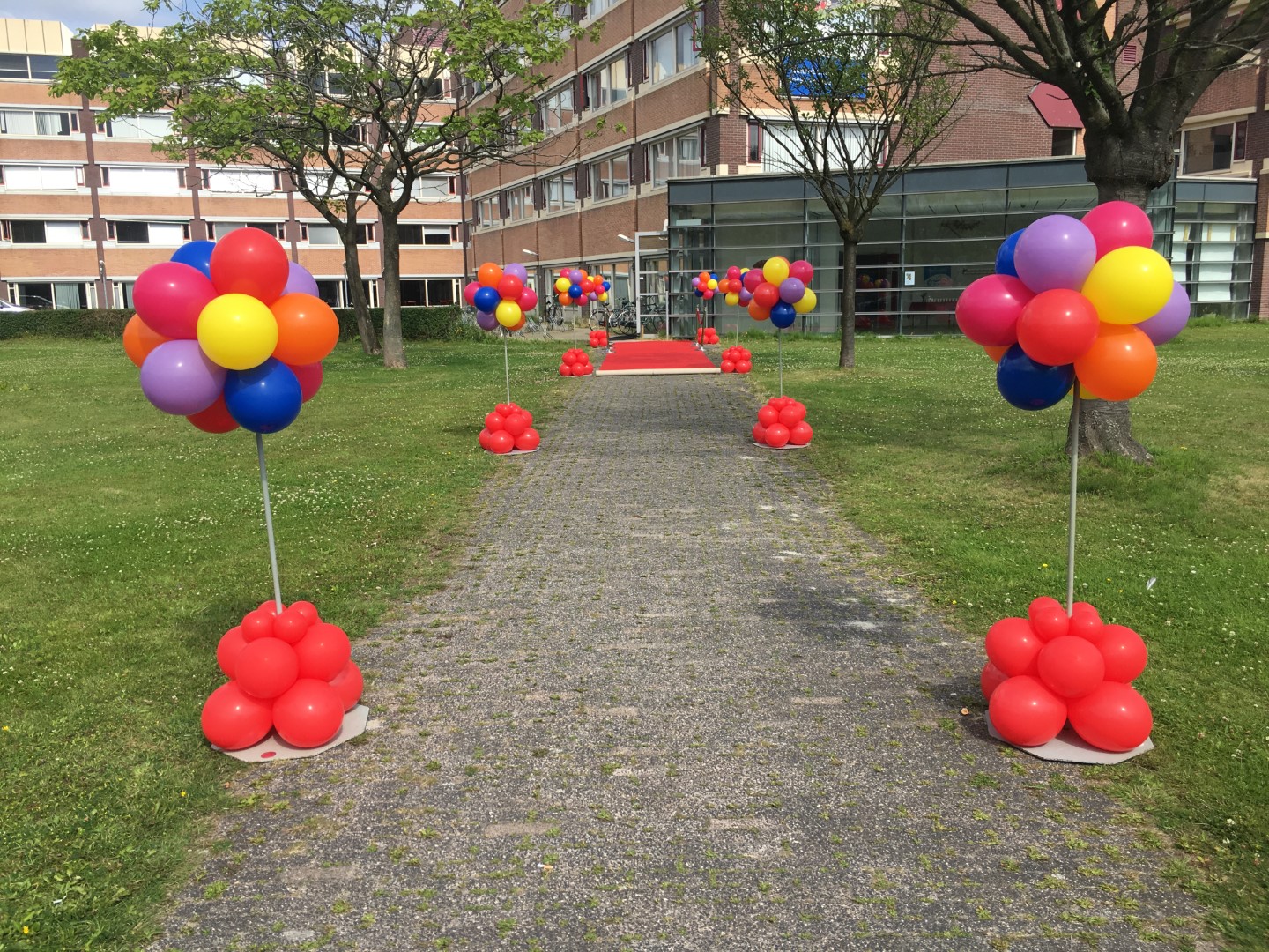 Erehaag Ballonnenpilaren. Een cluster ballonnen boven en onder met een lege stam.